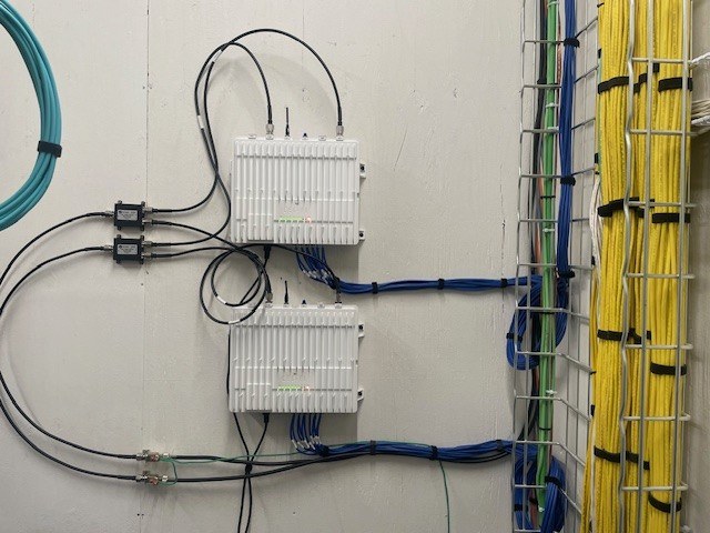 Two Nextivity Cel-Fi QUATRA cellular booster units on a wall