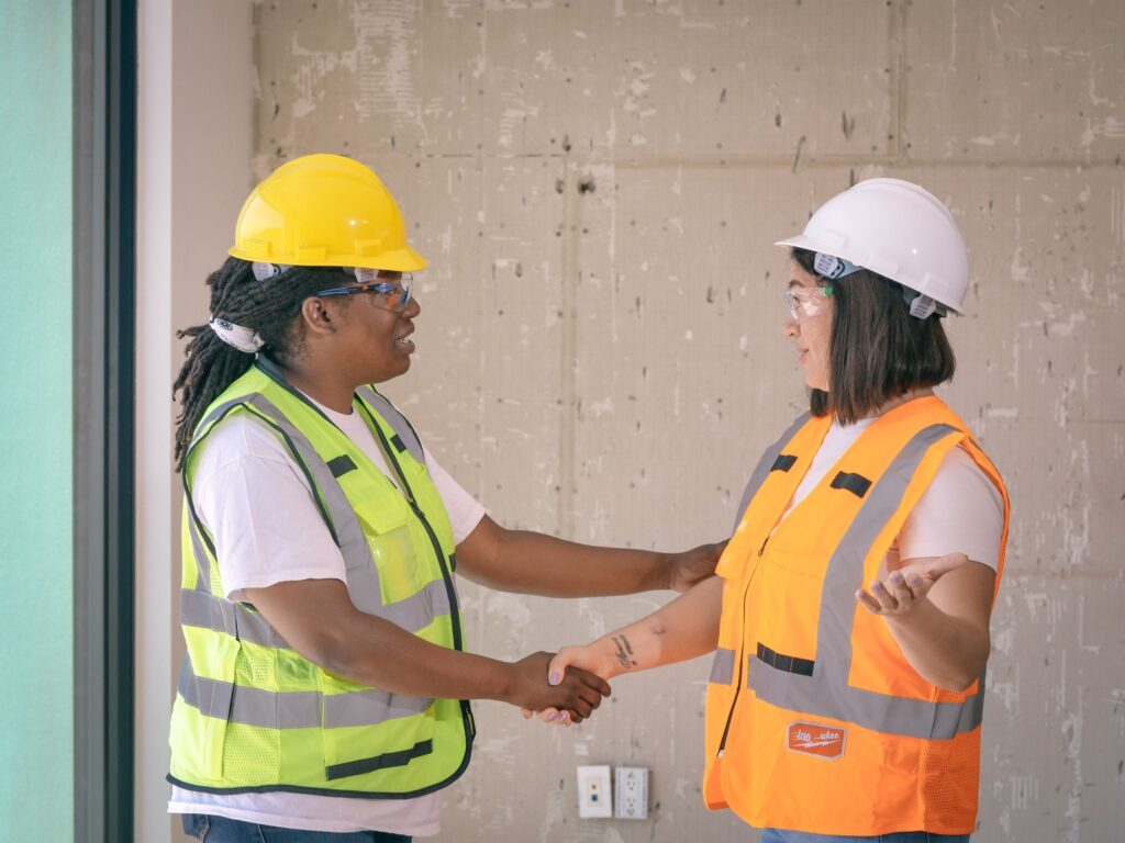 Two people shaking hands during a commercial site walkthrough